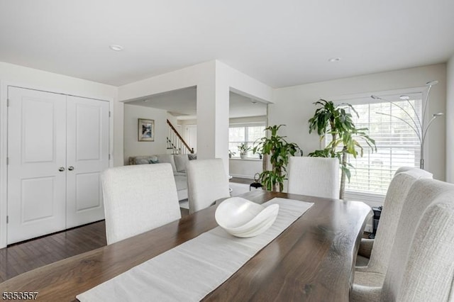 dining area with stairs and wood finished floors