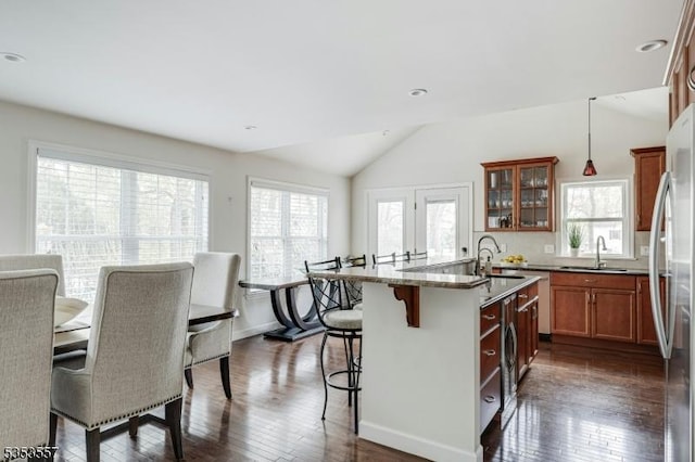 kitchen with freestanding refrigerator, plenty of natural light, and a sink