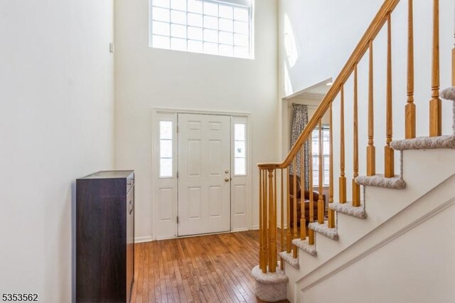 23 Schenck Ln, Franklin Twp, NJ 08873 - entrance foyer featuring a high ceiling, stairs, hardwood / wood-style floors, and a healthy amount of sunlight