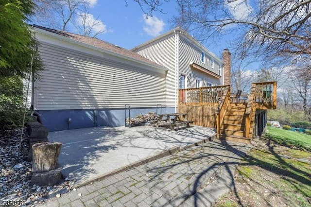 exterior space featuring a deck and stairs