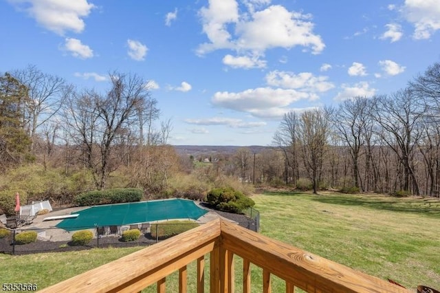 exterior space featuring a diving board, a yard, and a covered pool