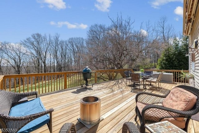 deck featuring a grill and outdoor dining area