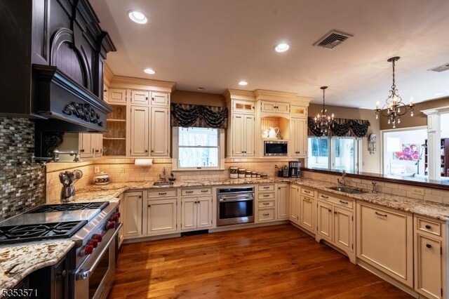 2 Natale Dr, Sparta Twp, NJ 07871 - kitchen with a sink, appliances with stainless steel finishes, decorative backsplash, and a chandelier