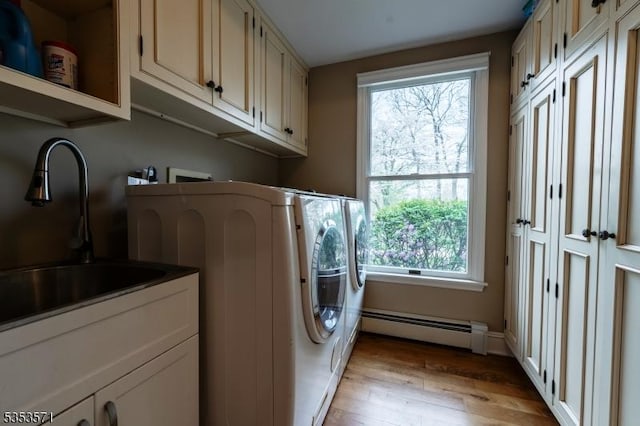 2 Natale Dr, Sparta Twp, NJ 07871 - laundry area featuring a sink, cabinet space, a baseboard heating unit, and a healthy amount of sunlight