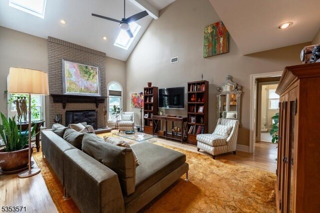 2 Natale Dr, Sparta Twp, NJ 07871 - living area featuring ceiling fan, plenty of natural light, visible vents, a skylight, and high vaulted ceiling