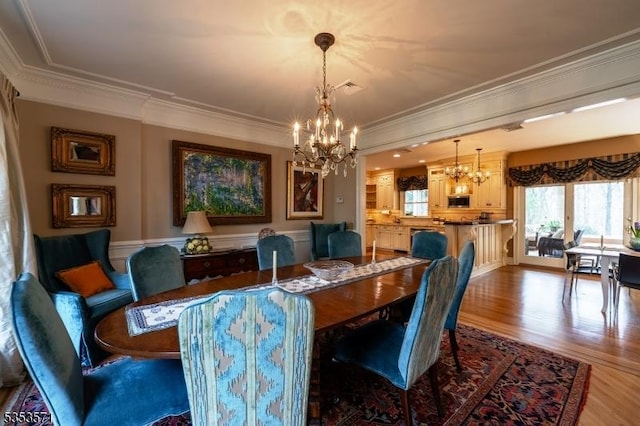 2 Natale Dr, Sparta Twp, NJ 07871 - dining area with a chandelier, ornamental molding, wood finished floors, and a healthy amount of sunlight
