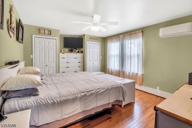 67 May St, Hawthorne Boro, NJ 07506 - bedroom with an AC wall unit, hardwood / wood-style flooring, ceiling fan, and two closets