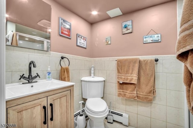67 May St, Hawthorne Boro, NJ 07506 - bathroom featuring a baseboard heating unit, vanity, tile walls, a stall shower, and a wainscoted wall
