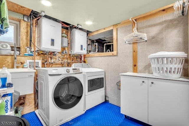 67 May St, Hawthorne Boro, NJ 07506 - laundry area featuring washer and dryer, tankless water heater, cabinet space, and tile walls