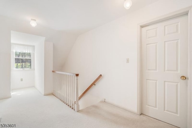 interior space featuring carpet flooring and lofted ceiling