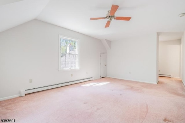 interior space featuring ceiling fan, light carpet, a baseboard heating unit, and lofted ceiling