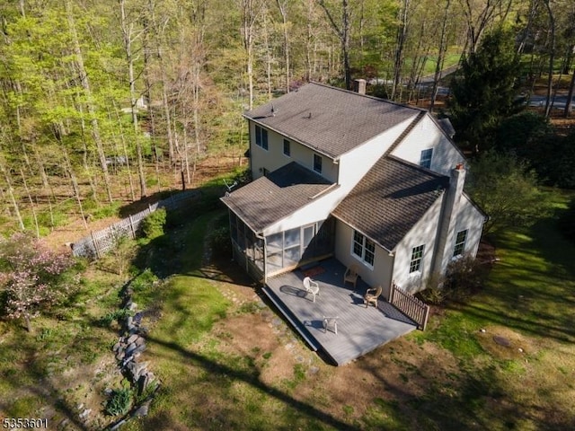birds eye view of property featuring a view of trees