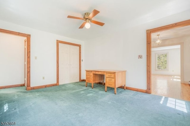 interior space with baseboards and a ceiling fan