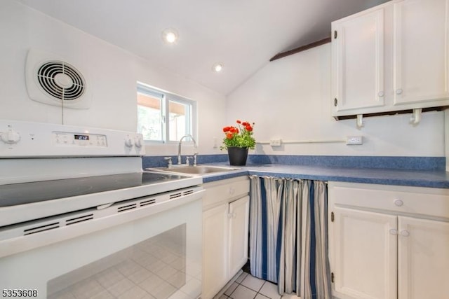 kitchen with electric range, a sink, light tile patterned floors, white cabinets, and lofted ceiling