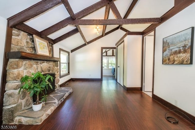 unfurnished living room with baseboards, lofted ceiling with beams, dark wood-style floors, and a fireplace