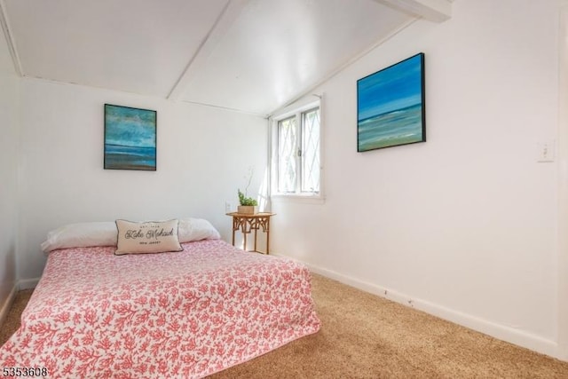 bedroom featuring carpet flooring, beamed ceiling, and baseboards