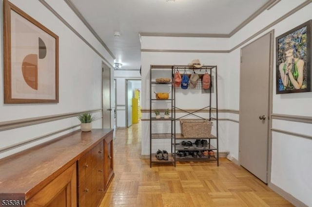 corridor with crown molding and baseboards