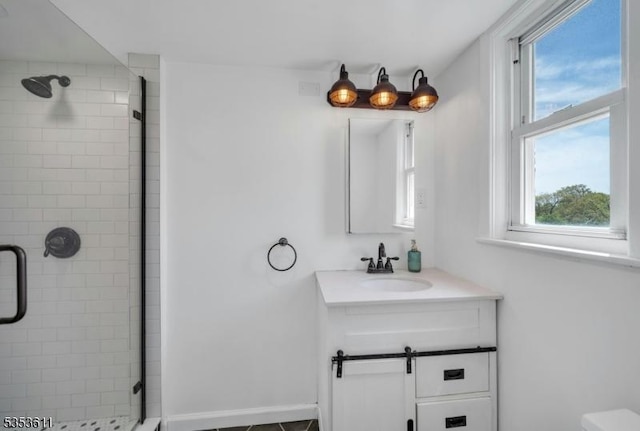 bathroom featuring plenty of natural light, a stall shower, and vanity