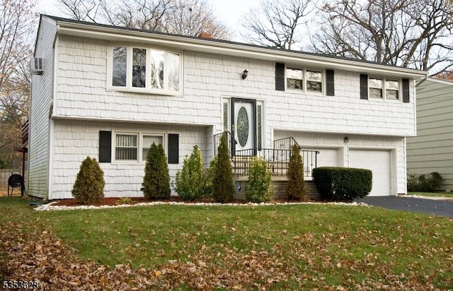 split foyer home featuring a front lawn, driveway, and a garage