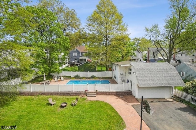 view of swimming pool featuring a lawn, a fenced in pool, a fenced backyard, and a residential view
