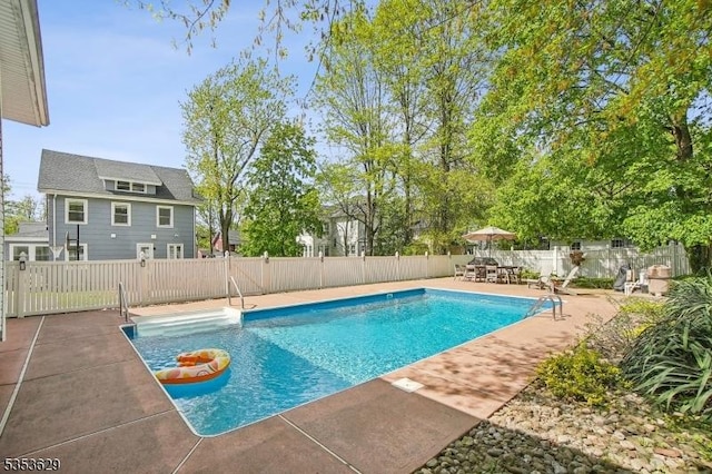 view of pool featuring a fenced in pool, a fenced backyard, and a patio area