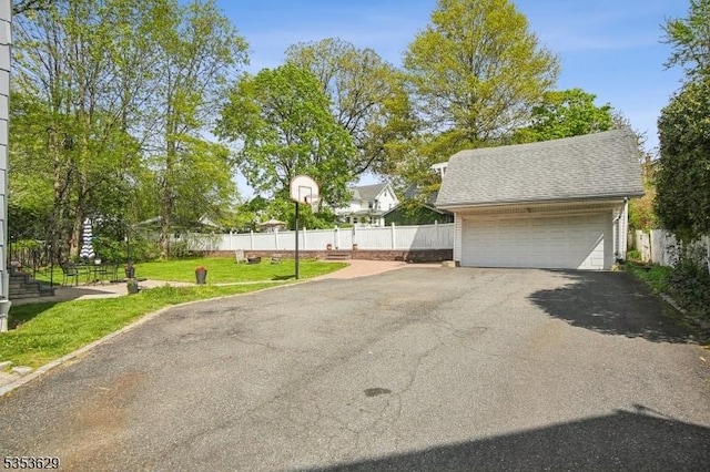 detached garage featuring fence