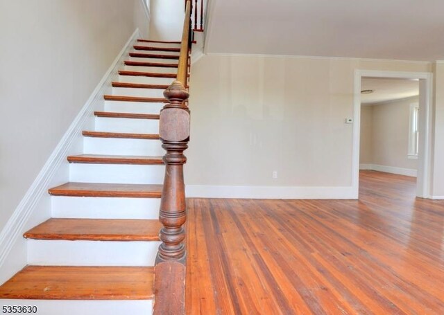 stairs featuring baseboards and wood finished floors