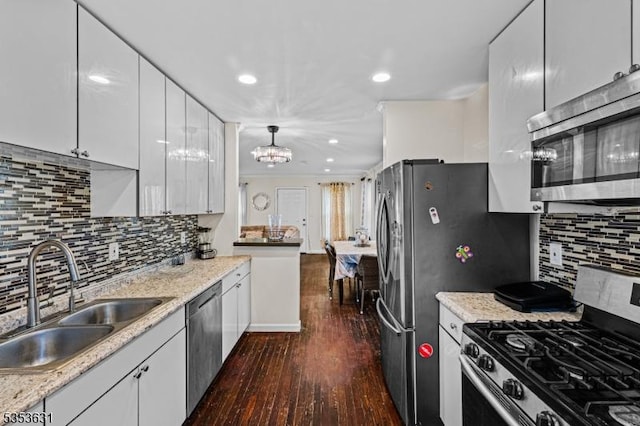 kitchen featuring a sink, dark wood-style flooring, appliances with stainless steel finishes, and white cabinetry