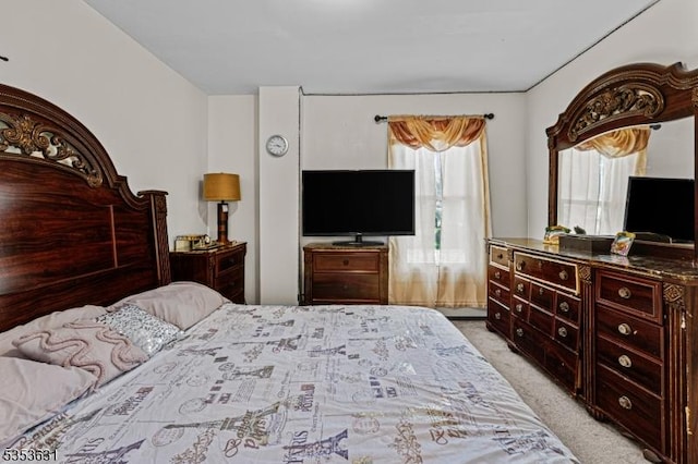 bedroom featuring light carpet
