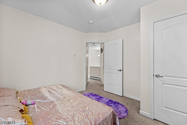bedroom with baseboards, carpet flooring, and a baseboard radiator