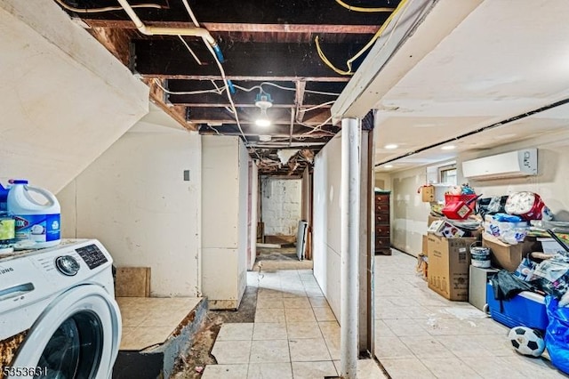 unfinished below grade area featuring a wall mounted air conditioner and washer / clothes dryer