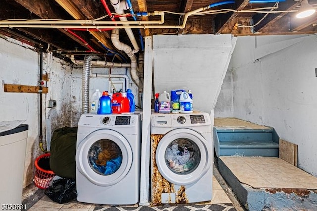 washroom with independent washer and dryer and laundry area