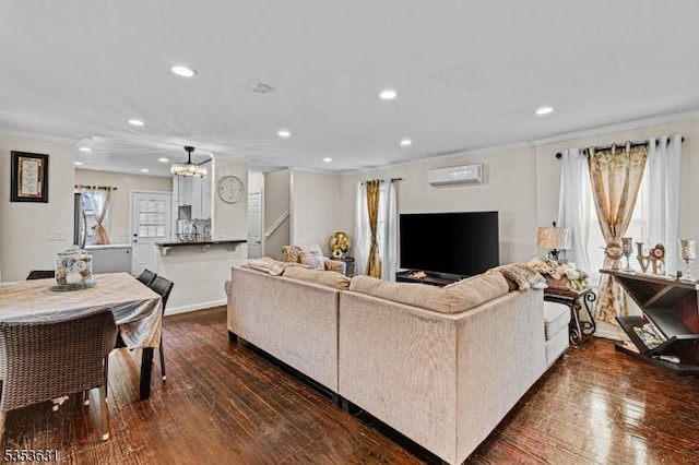 living room featuring crown molding, an inviting chandelier, recessed lighting, an AC wall unit, and dark wood-type flooring