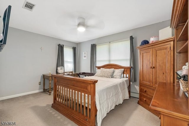 bedroom featuring visible vents, baseboards, light colored carpet, a baseboard heating unit, and a ceiling fan