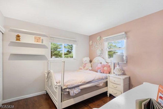 bedroom featuring baseboards and dark wood finished floors