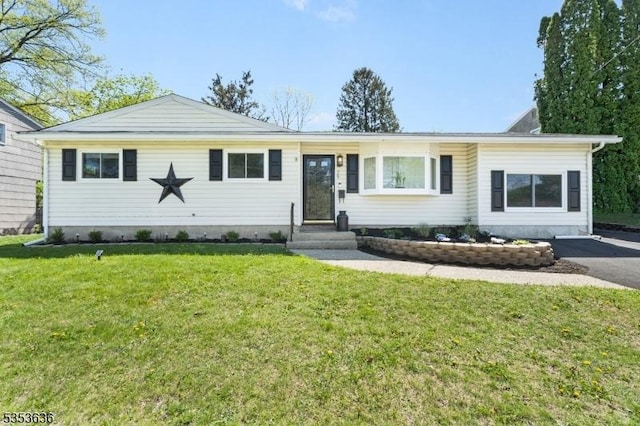 ranch-style house with entry steps and a front lawn