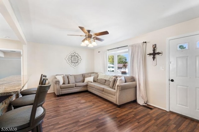 living room with a ceiling fan and dark wood finished floors