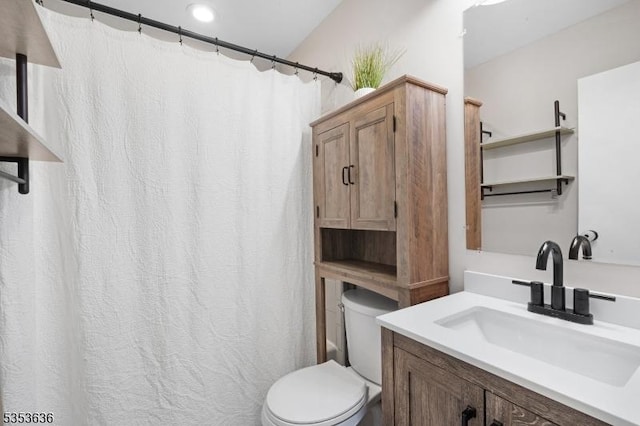 bathroom featuring vanity, a shower with shower curtain, and toilet