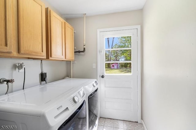 washroom featuring light tile patterned floors, cabinet space, and washer and dryer