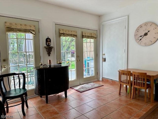 doorway to outside featuring tile patterned flooring and french doors