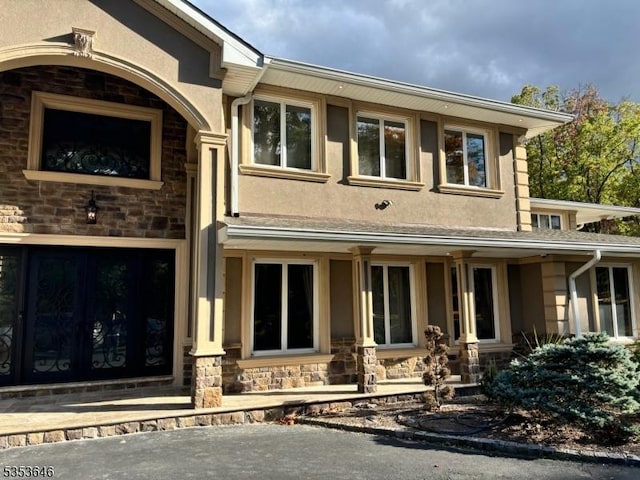 50 Perryville Rd, Union Twp, NJ 08867 - view of front of property featuring stucco siding, covered porch, and stone siding