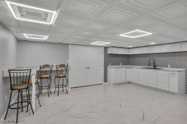 50 Perryville Rd, Union Twp, NJ 08867 - kitchen with a sink, light countertops, white cabinets, and marble finish floor