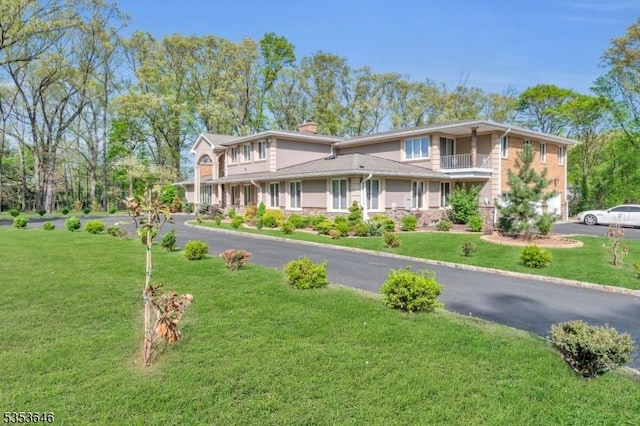 50 Perryville Rd, Union Twp, NJ 08867 - view of front facade with a balcony, a chimney, aphalt driveway, and a front yard