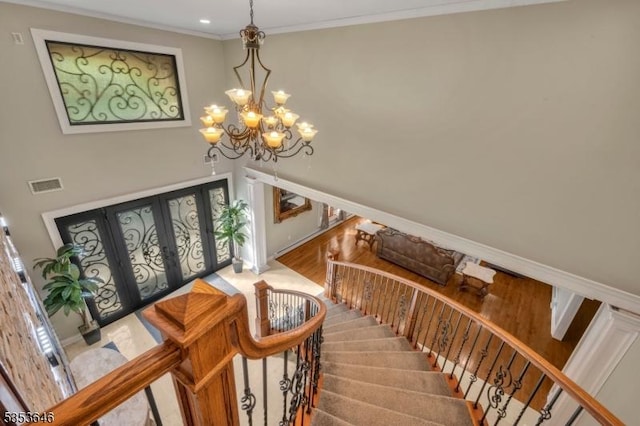 50 Perryville Rd, Union Twp, NJ 08867 - foyer with visible vents, ornamental molding, stairs, an inviting chandelier, and french doors