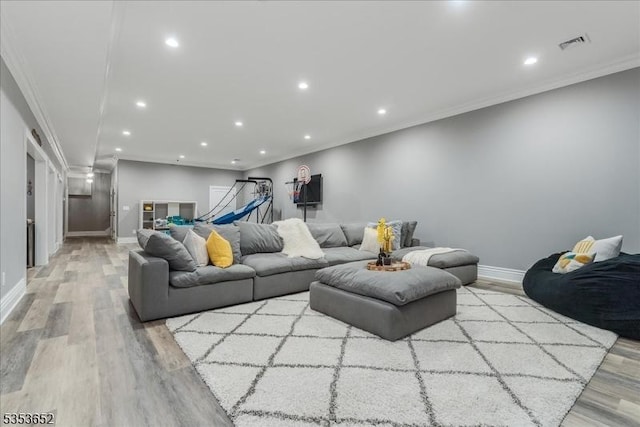 living room featuring recessed lighting, baseboards, and wood finished floors