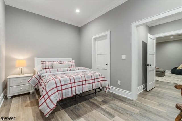bedroom featuring baseboards, ornamental molding, recessed lighting, and wood finished floors