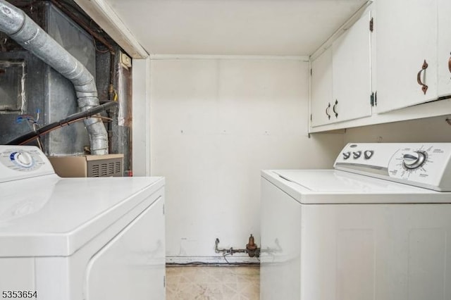 laundry room with cabinet space and washing machine and dryer