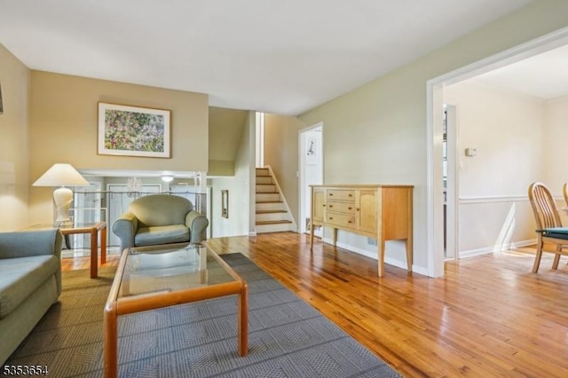 living room with wood finished floors and stairway