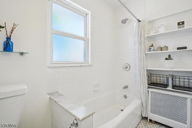 bathroom featuring shower / bath combo, toilet, and radiator