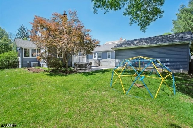 back of house with a patio area, a yard, and central AC unit